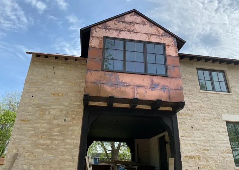 Copper metal panel facade on a stone building for Skylight Installation in Prairieville