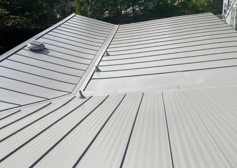 Solar attic fan installed on a metal roof for Roof Ventilation in Prairieville
