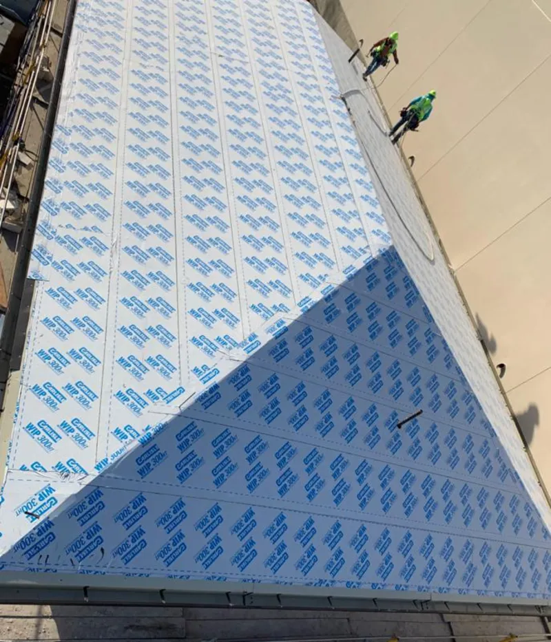 Professional roofers installing underlayment on a metal roof in Prairieville